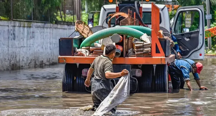 Crew managing firefighting water outside a home